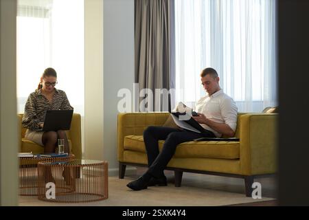 Collaborating on Project in Modern Office Lounge Stock Photo