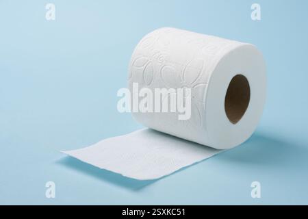 Top view of toilet paper roll on blue background Stock Photo