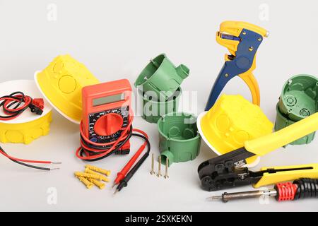 Different electrician's tools on light background Stock Photo