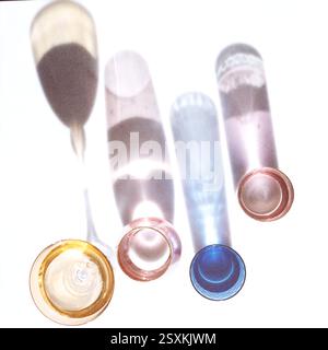 Fancy retro colorful and various shapes drinking glasses casting hard shadows on bright background. Grunge and noise effect applied, retro vintage sty Stock Photo