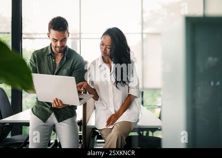 Mixed team of software engineers brainstorming ideas. Diverse app developers collaborating as group Stock Photo