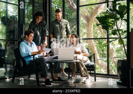 Mixed team of software engineers brainstorming ideas. Diverse app developers collaborating as group Stock Photo