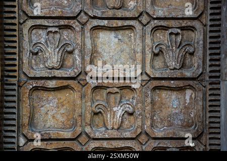Beautifully detailed wall panels feature floral motifs created from stone, found in a historical building that reflects craftsmanship and style of the Stock Photo