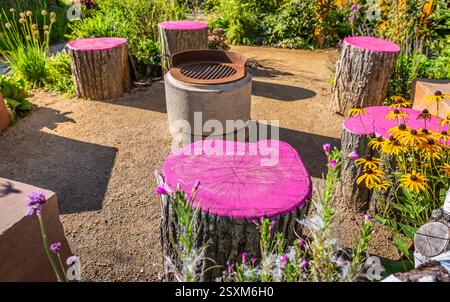 Cozy seating area in a garden or patio made from natural wooden logs Stock Photo