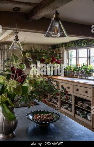 Glass pendant lights with flower garlands in renovated East Sussex Tudor farmhouse dating from 1540, England, UK. Stock Photo