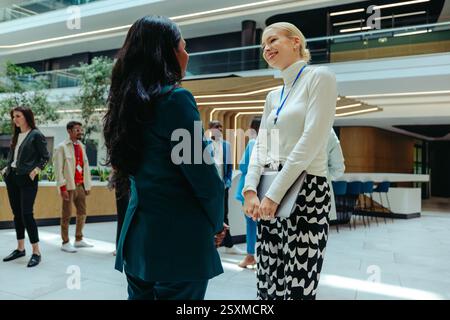 Female professionals in a high-end office setting discussing wealth management and fostering teamwork. The image captures a collaborative and professi Stock Photo