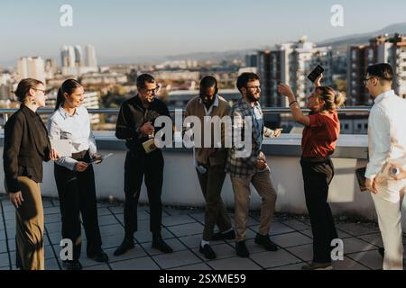 Multicultural business team enjoying a break with dance and music Stock Photo