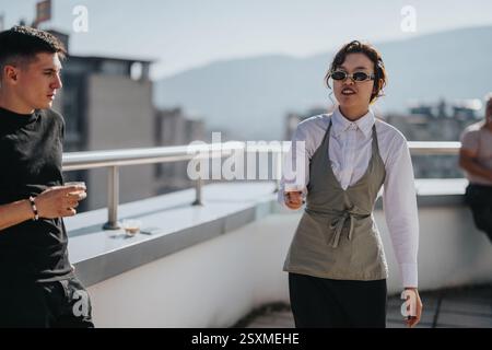 Multicultural business workers enjoying break on rooftop terrace Stock Photo