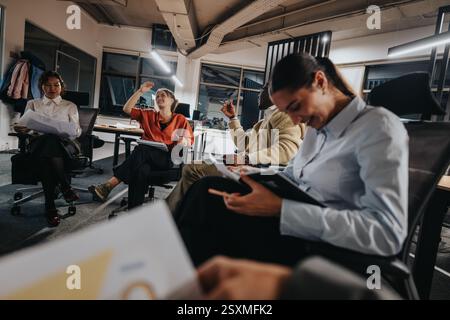 Business coworkers enjoying a relaxed meeting in a modern office setting Stock Photo