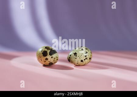 Two quail eggs on pastel background, Easter Stock Photo