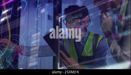 Image of data processing over diverse colleagues using tablet in server room Stock Photo