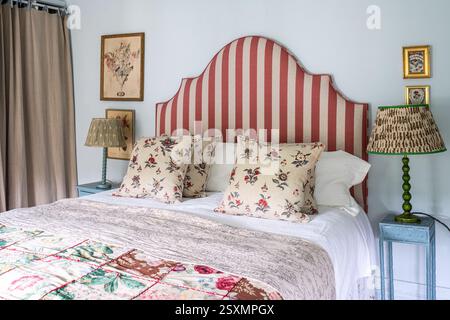 Contrasting fabrics and bedside lamps in Chalford weavers cottage in the Cotswolds, Gloucestershire, England, UK. Stock Photo