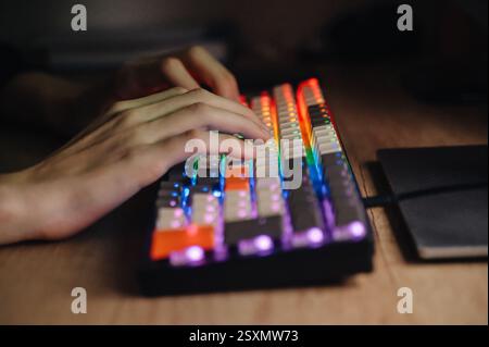 A close-up of a keyboard with multicolored glowing keys. Ideal for technology, gaming, RGB lighting Stock Photo