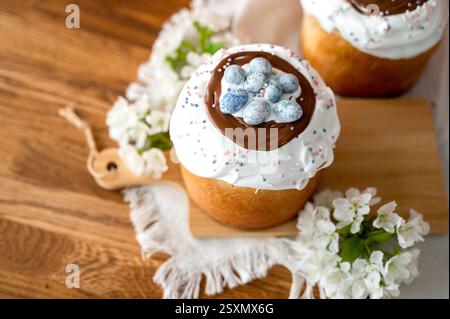 Appetizing Easter cake made from yeast dough, beautifully decorated, set against a pink background Stock Photo