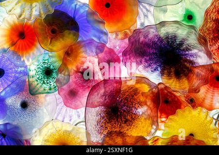 Colorful array of glass flower vases with different colors and shapes. The vases are arranged in a way that creates a sense of depth and movement. Sce Stock Photo