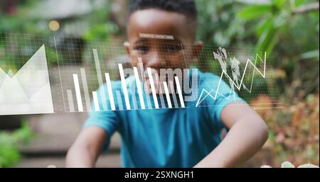 Image of financial data processing over african american boy planting plant Stock Photo