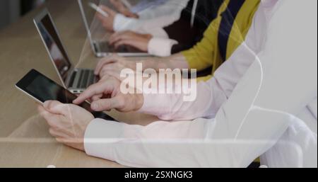 Typing on tablets and laptops, people working with data processing image over them Stock Photo