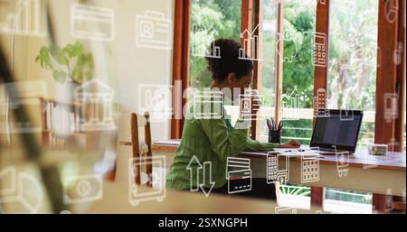 Working on laptop, woman surrounded by business analytics and data icons image Stock Photo