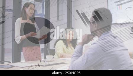 Financial data charts image over business meeting in modern office Stock Photo