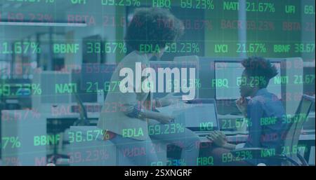 Image of stock market over diverse business people discussing work Stock Photo