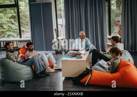 Professor engaging with students in a relaxed learning setting Stock Photo