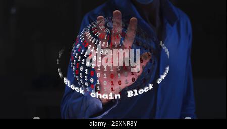 Image of globe with data processing and text over hand of caucasian man on black background Stock Photo