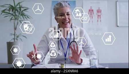 Image of eco icons and data processing over caucasian female doctor Stock Photo