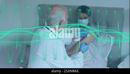 Medical data processing image over doctor examining patient in hospital bed Stock Photo