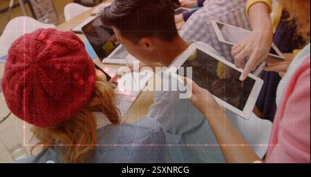 Graph and data points image over people working with tablets and laptops Stock Photo
