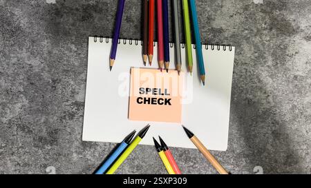 Concept of Spell Check write on sticky notes isolated on Wooden Table. Stock Photo