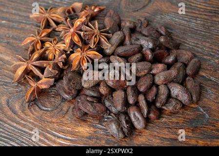 Broken dark chocolate and cocoa beans on the table Stock Photo