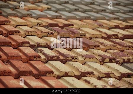 Colorful square interlocking ceramic roof tiles make an abstract pattern and interesting background. Stock Photo