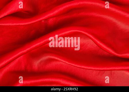 Macro blank photography of red satin cloth, fabric textured pattern, smooth luxury shiny clothing Stock Photo