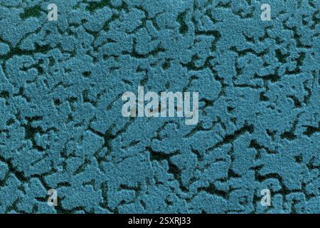 Blue and black background from a soft upholstery textile material with wave abstract pattern, macro. Texture of turquoise felt fabric. Velvet cerulean Stock Photo