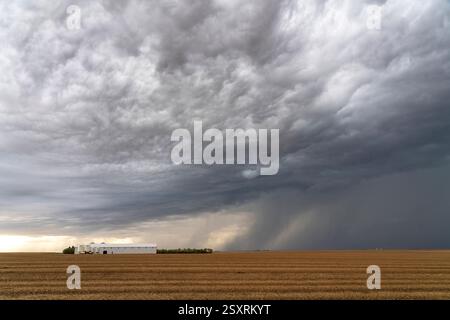 Dramatic storm clouds forming over a farm in the prairies of canada Stock Photo