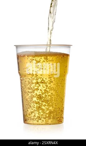 fresh apple juice pouring in to plastic cup isolated on white background Stock Photo