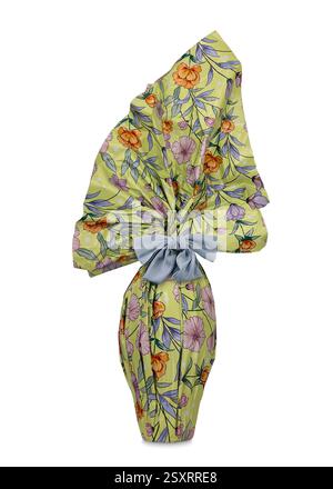 Easter chocolate egg wrapped in paper with multicolored flower designs with light blue satin bow isolated on white Stock Photo