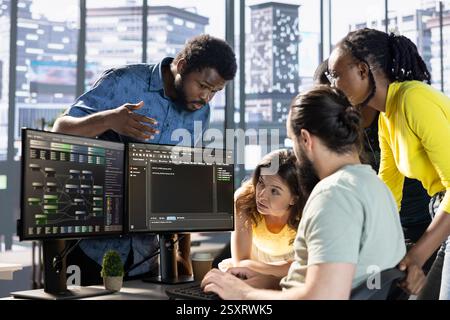 Team of developers doing brainstorming to create machine learning models that can process and analyze data to improve decision making processes. IT staff members working together in office Stock Photo