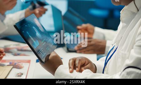 Medical team collaborates on diagnostic procedures and treatment plans. Professionals in radiology and radiography support accurate diagnosis and effective disease prevention, insurance. Camera A. Stock Photo