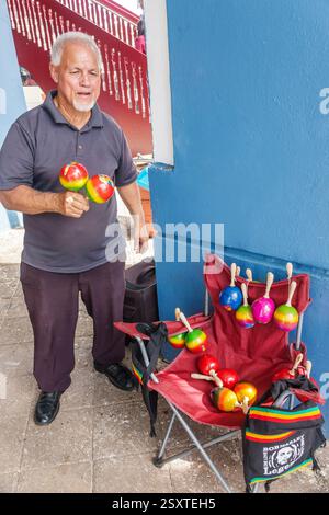 San Juan Puerto Rico,Viejo Old San Juan,Hispanic man resident,sidewalk vendor,shaking playing maracas,handmade musical instruments,Puerto Rican cultur Stock Photo