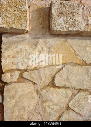 Top-Down Close-Up of Irregular Yellow Riyadh Lime Stone with Geometric Edge Stones Pattern in Saudi Arabia Stock Photo
