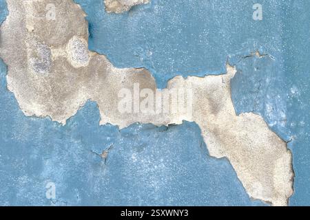 Peeling blue paint on aged concrete wall. Abstract grunge background Stock Photo