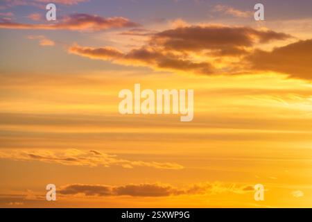 Dramatic red, orange, and yellow clouds in a real fiery sky at sunset. High resolution photography for sky replacement, background or graphic design Stock Photo