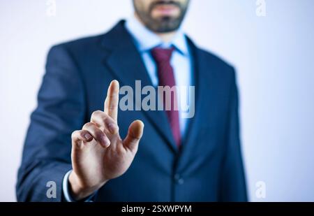 Young business man touching an imaginary screen Stock Photo