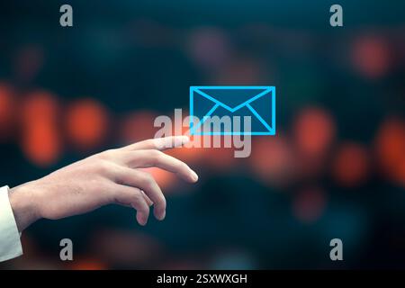 Businessman touching email icon on a virtual screen on bokeh background Stock Photo