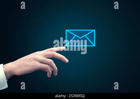 Businessman touching email icon on a virtual screen Stock Photo