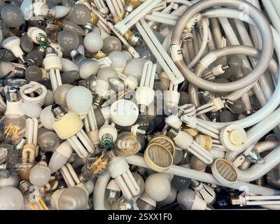 View from above heap of various discarded fluorescent light bulbs Stock Photo