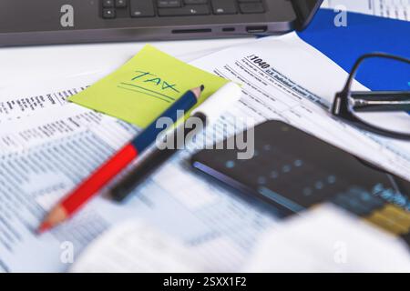 Accountant calculating taxes using calculator app on smartphone Stock Photo