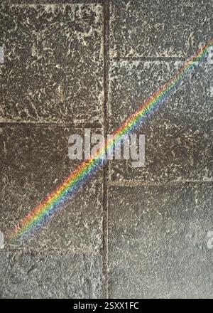 View from above rainbow prism over gray stone surface Stock Photo