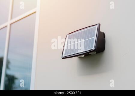Small solar panel installed on the wall of the house Green energy concept. Selective focus. Stock Photo
